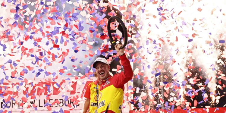 Credit: NORTH WILKESBORO, NORTH CAROLINA - JULY 19: Joey Logano, driver of the #22 Shell-Pennzoil Ford, celebrates in victory lane after winning the NASCAR Cup Series Window World 450 at North Wilkesboro Speedway on July 19, 2026 in North Wilkesboro, North Carolina. (Photo by Meg Oliphant/Getty Images).
